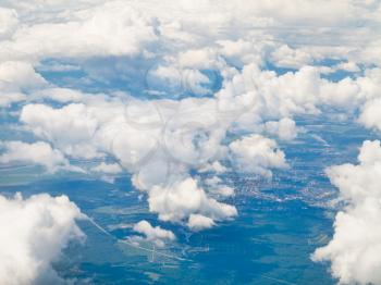 above view of white clouds in blue sky and green earth under clouds