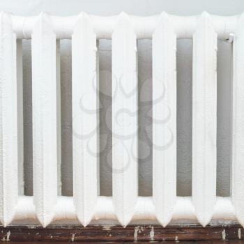 white painted iron radiator of water heating in home