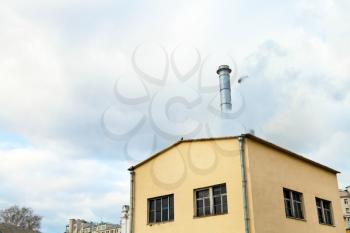 Central heating station and fume from chimney in cold autumn day