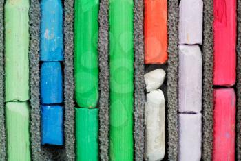 set of many-coloured used artistic dry pastel close up