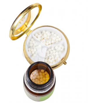 glass brown jar and mirror pill box with homeopathy sugar balls in isolated on white background