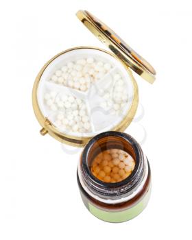 glass brown jar and pill box with homeopathy sugar balls in isolated on white background