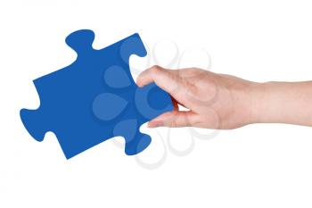female hand with blue puzzle piece isolated on white background