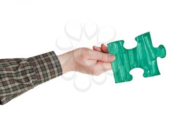 male hand with painted green puzzle piece isolated on white background