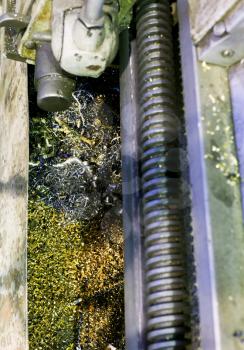 metal turnings in sump of lathe machine close up