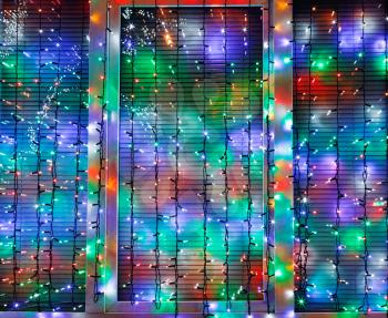 outdoor Xmas lights decorate window in night