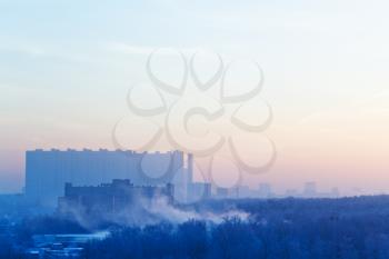 sunrise mist and blue and pink sky over city in cold winter