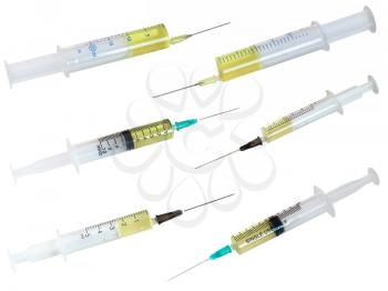 set of syringes filled with yellow liquid isolated on white background