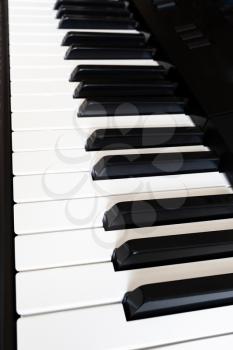 side view of black and white keyboard of digital piano close up