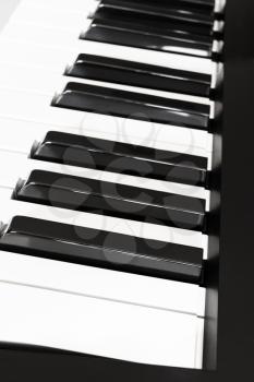 side view of black and white keys of musical digital keyboard close up