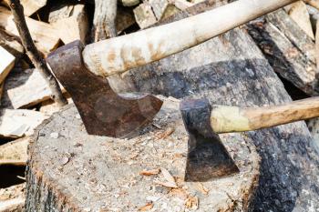 two axes in block for chopping firewood close up