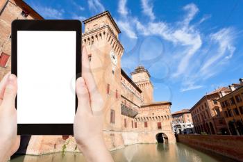 travel concept - tourist photograph castle estense Castello in Ferrara city, Italy in autumn on tablet pc with cut out screen with blank place for advertising logo