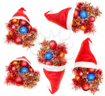 christmas gifts - set of red santa hats with xmas decorations on white background