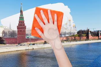 travel concept - hand deletes summer view of Moscow by orange cloth from image and winter snowing cityscape is appearing