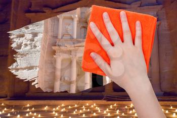 travel concept - hand deletes night view of Petra by orange rag from image and day view of ancient town Petra is appearing