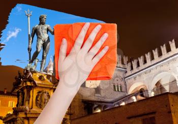 travel concept - hand deletes Bologna night scene by orange cloth from image and daily city view is appearing