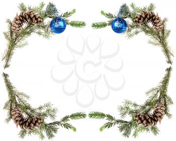 christmas greeting card frame - spruce tree twigs with cones and blue balls on white background