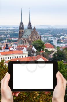 travel concept - tourist photographs Brno city with Cathedral of St Peter and Paulon on tablet pc with cut out screen with blank place for advertising logo