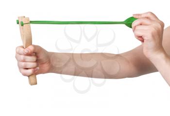 hands pulling rubber band of wooden slingshot isolated on white background