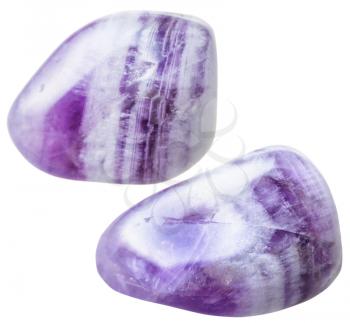 natural mineral gem stone - two Amethyst gemstones tumbling isolated on white background close up