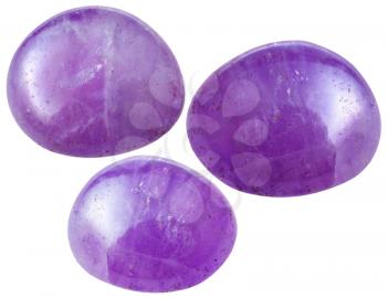 natural mineral gem stone - three Amethyst gemstones isolated on white background close up