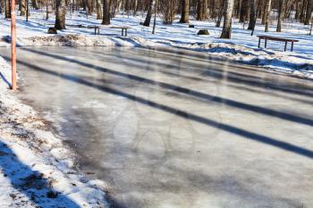 frozen sport ground in urban park in sunny winter day
