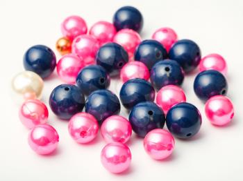 many blue and pink glass and plastic beads on white