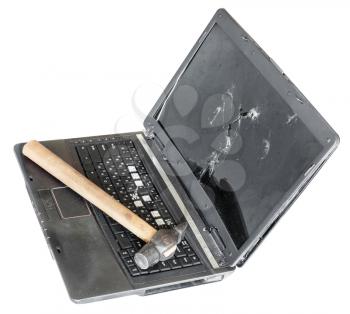 old broken laptop with hammer on keyboard isolated on white background