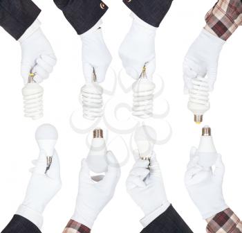 set of hands in textile gloves hold energy saving lamps isolated on white background