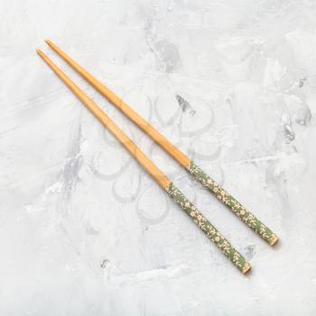 food concept - wooden chopsticks (Hashi) on concrete board