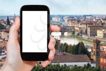 travel concept - tourist photographs Florence city with arno river on smartphone with cut out screen with blank place for advertising in Italy
