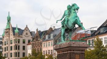 statue Absalon on Hojbro Plads square and urban houses in Copenhagen city
