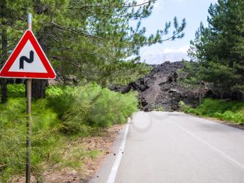 travel to Italy - hardened lava flow closed road on slope of Etna volcano in Sicily
