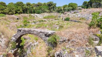 travel to Italy - arch in ancient roman Amphitheatre (Anfiteatro romano di Siracusa) in Archaeological Park (Parco Archeologico della Neapolis) of Syracuse city in Sicily