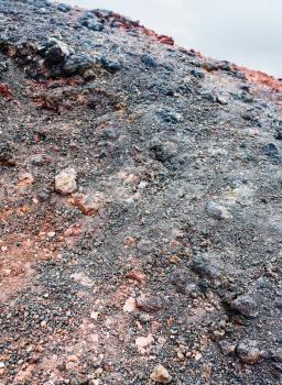 travel to Italy - black and red clinker on volcanic slope of Mount Etna in Sicily in summer day