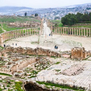 Travel to Middle East country Kingdom of Jordan - above view of The Oval Forum and Cardo Maximus road in Jerash (ancient Gerasa) town in winter