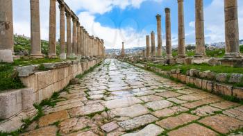 Travel to Middle East country Kingdom of Jordan - wet Cardo Maximus street in Jerash (ancient Gerasa) town in winter