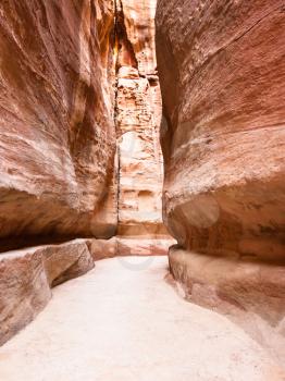 Travel to Middle East country Kingdom of Jordan - narrow Al Siq passage to ancient Petra town in winter