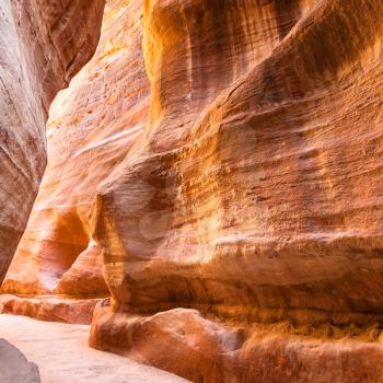 Travel to Middle East country Kingdom of Jordan - sandstone walls of Al Siq passage to ancient Petra town in winter