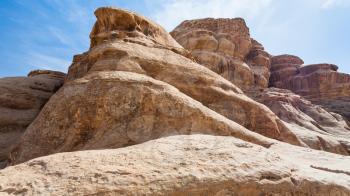 Travel to Middle East country Kingdom of Jordan - old sandstone mountains in Wadi Rum desert in sunny winter day