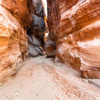 Travel to Middle East country Kingdom of Jordan - sandstone walls of Al Siq gorge to ancient Petra town in winter