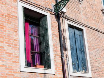 travel to Italy - windows of urban house in Santa Croce district in Venice city in spring