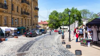 KIEV, UKRAINE - MAY 6, 2017: tourists and gift market on Andriyivskyy Descent in Kiev city in spring. This street connecting Upper Town district and the historical commercial Podil district