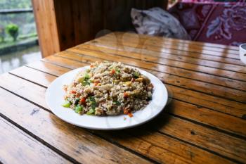 travel to China - fried rice with vegetables on plate in rustic eatery in area Dazhai Longsheng Rice Terraces (Dragon's Backbone terrace, Longji Rice Terraces) country in spring