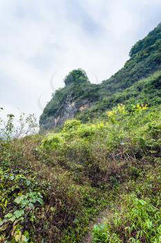 travel to China - overgrown slope of karst mountain in Yangshuo County in spring season