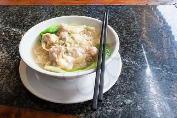 travel to China - Dim sum with noodle soup with chopsticks in chinese cafe in Yangshuo town County