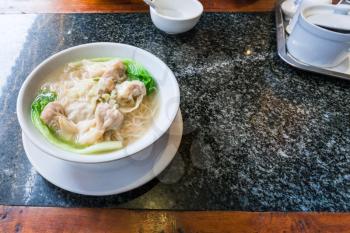 travel to China - Dim sum with noodle soup in bowl on table in chinese cafe in Yangshuo town County