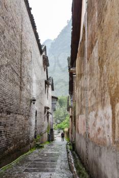 travel to China - narrow street in Xingping town of Yangshuo county in spring rain day