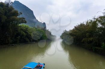 travel to China - chinese boat on river near karst peaks near Xingping town in Yangshuo county in spring