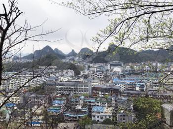 travel to China - above view of Guilin city and green mountains in rain in spring season
